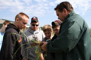 Professor and students evaluating soil