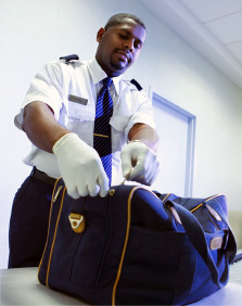 TSA Agent checking luggage