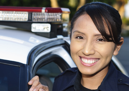 Criminal Justice - Police Officer standing next to police vehicle