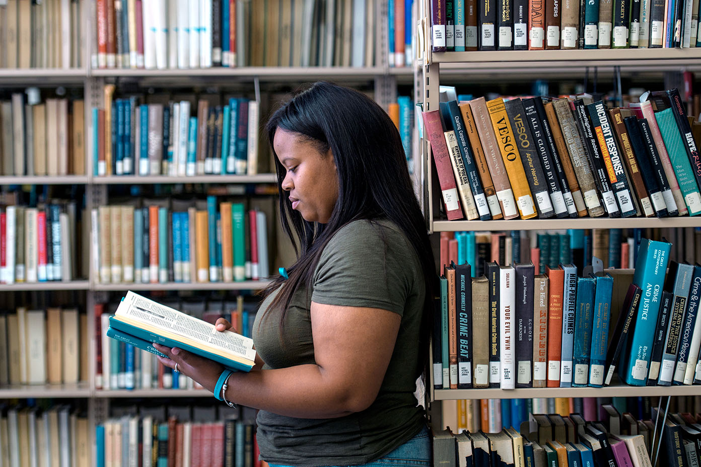 KSU Student in library with book open