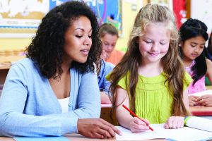 Picture of an adult women helping a young girl